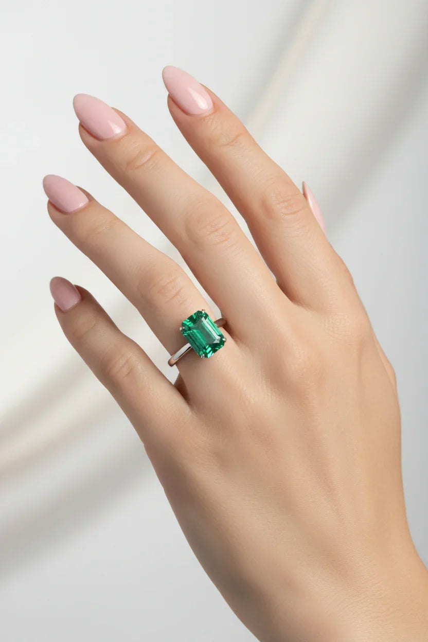 Emerald gemstone on a gray background